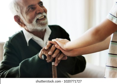 Grandson holding grandpa's hands - Shutterstock ID 1020771727