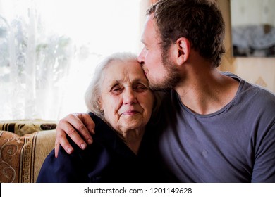 Grandson kisses grandmother