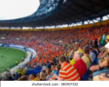Grandstand stadium with football fans generic background, intentionally blurred post production. Oval podium football stadium with fans generic background, intentionally blurred post production.