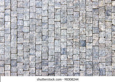 Granite cobblestoned pavement background. Full frame of regular square cobbles in rows. Natural stone textured background - Powered by Shutterstock