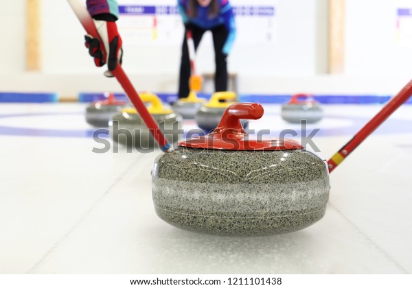 Granite curling stones.Curling on the ice. Team\
curling game.\
