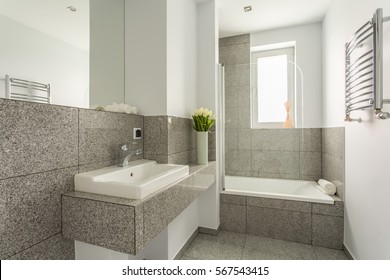 Granite Modern Bathroom Interior With Minimalist Washbasin And Bathtub