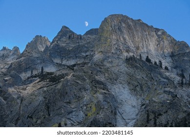 Granite Mountain Peak With A Half Moon On The Top Of The Sky