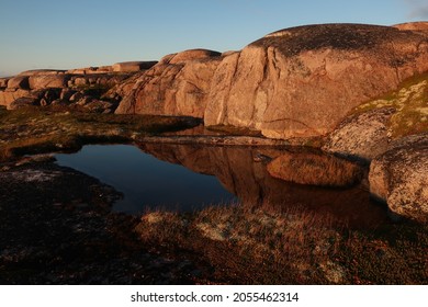 Granite rocks and lake sunset view near Teriberka, Murmansk region, Far North Russia