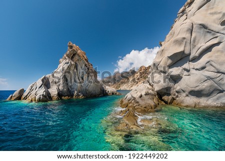 Granite rocks shaped by the sea at the small harbor of Magganitis on the south coast of the Greek island of Ikaria in the North Aegean