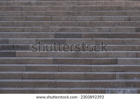 Granite staircase going to the top. The texture of a granite staircase. The texture of the steps.