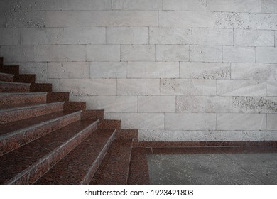 Granite stairs on the background of a wall of shell rock side view