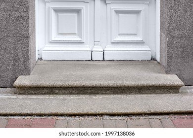 Granite Threshold At The Entrance Door Made Of White Wood And Gray Facade Cladding Of An Old Retro Building Close-up Front View, Nobody.