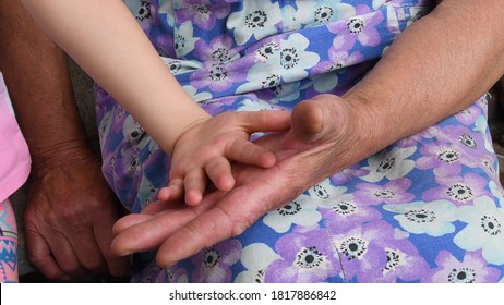 Granny Touch Small Child Hands By Her Wrinkled Aged Hands. Hands Of Grandmother And Grandchild. Diverse Hands Of 4 Year Old Child And 81 Year Old Woman