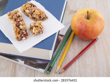 Granola Bar, Apple, Books And Pencils