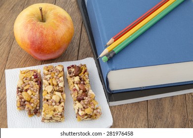 Granola Bar, Apple, Books And Pencils