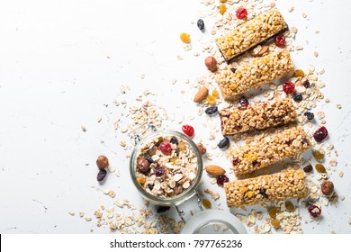 Granola bar. Healthy sweet dessert snack. Cereal granola bar with nuts, fruit and berries on a white stone table. Top view copy space.