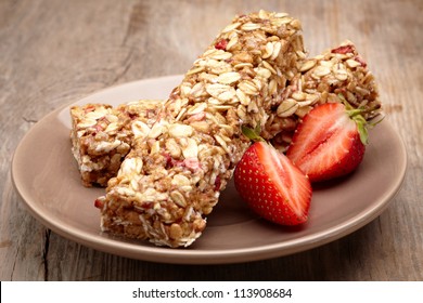 Granola Bar With Strawberries On Plate