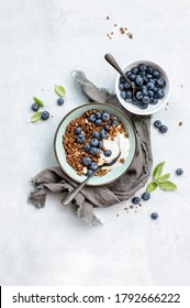 Granola And Blueberry Breakfast With Plain Yogurt Served In A Bowl, Overhead View