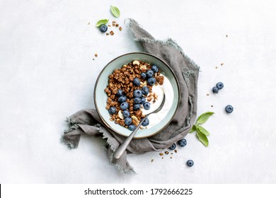 Granola And Blueberry Breakfast With Plain Yogurt Served In A Bowl, Overhead View