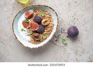 Granola bowl with greek yogurt, fresh and dried fig fruits, flat lay on a beige granite background, horizontal shot - Powered by Shutterstock