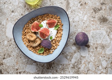 Granola bowl with yogurt, fresh and dried figs, top view on a light-brown granite background, horizontal shot with space - Powered by Shutterstock