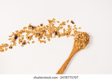 Granola with mixed nuts and died fruits in a wooden spoon, top view - Powered by Shutterstock