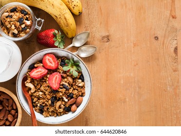 Granola, muesli, breakfast cereals, fresh fruits and milk. Healthy breakfast, healthy eating, diet food. Top view and copy space
