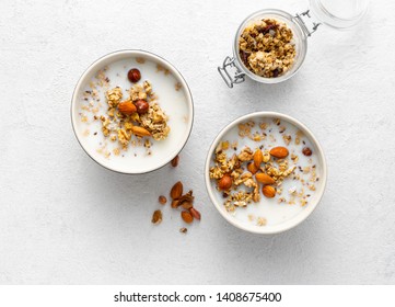 Granola nuts with milk, peanut butter in bowl. Healthy breakfast cereals top view - Powered by Shutterstock