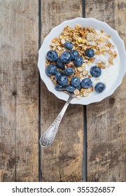 granola oatmeal with nuts, yogurt and blueberries - Shutterstock ID 355326857