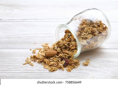 Granola superfood with almond and dry fruits in the glass jar on the white wooden table - Powered by Shutterstock