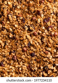 Granola Texture. Closeup View Of Homemade Almond, Hazelnut And Cranberry Muesli. Healthy Snack, Vegetarian Food Made Of Rolled Oats And Nuts Variety. Top View.