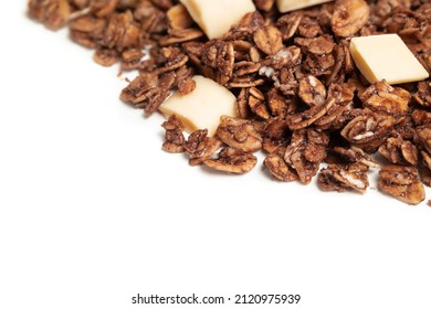 Granola With White Chocolate Pieces. Large Amount Of Chocolate Covered Baked Rolled Oats Clusters, Randomly Placed. Cereal Background Or Healthy Snack Texture. Isolated On White. Selective Focus.