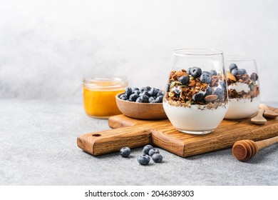 Granola with yoghurt and fresh blueberries in glass. Dessert parfait with berries for breakfast - Powered by Shutterstock
