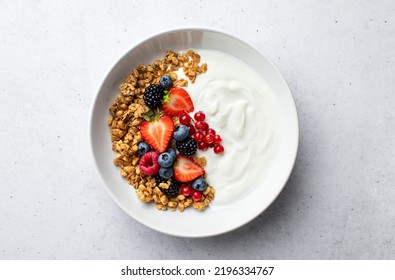 Granola with yogurt and fresh berries, top down view - Powered by Shutterstock