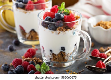 Granola Yogurt Parfait With Fresh Berries In Glass Mugs.