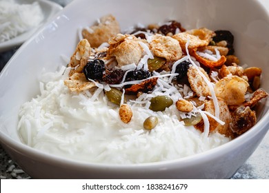 Granola With Yogurt And Shredded Coconut In White Bowl, Side View.  Healthy Breakfast Food.