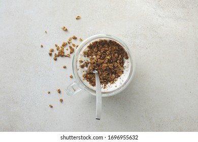 Granola Yougurt In Glass Cup With Spoon On Marble Background Top View Flat Lay