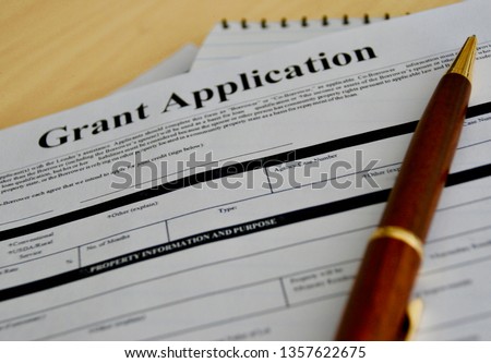 grant application form with pen