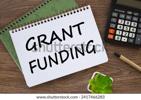Grant funding symbol. Beautiful wooden table. Business financing and grants concept. Copy space.