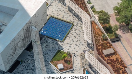 Grant Mosque Exterior Located In DIFC District Aerial Timelapse During All Day From Above With Shadows Moving Fast. Promenade On Gate Avenue With Trees And Green Lawn