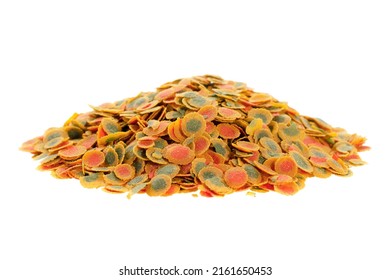 Granular food for aquarium fish isolated on white background. Pile of flakes for feeding tropical aquarium fish. Fish food in flakes. Food for fish in an aquarium isolated on a white background.