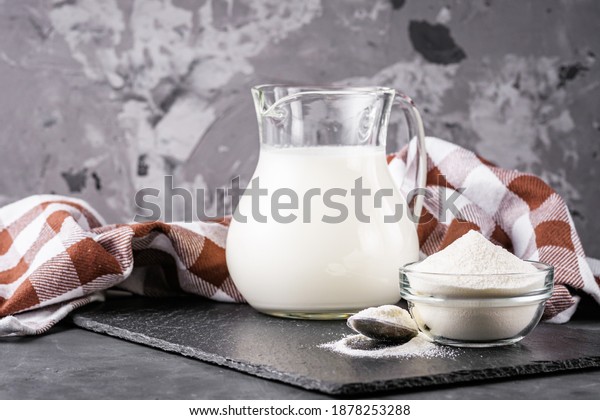 granulated milk
powder on a dark stone
background