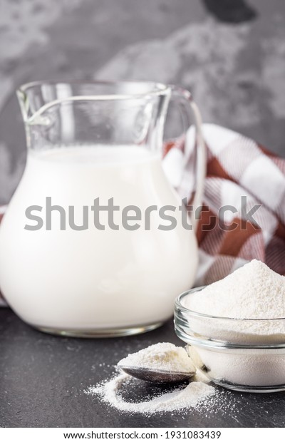 granulated milk\
powder on a dark stone\
background.