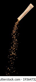 Granules Of Freeze Dried Instant Coffee Pouring From The Stick Packaging On Black Background