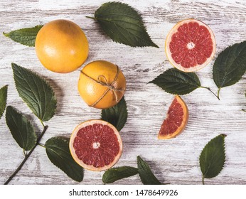 Grape fruit on a table with some leafs
