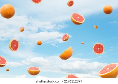 Grapefruit Citrus Flying. Blue Sky With Clouds In The Background. Surreal Aesthetic Fruit Outdoor Summer Food Concept.