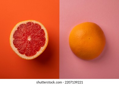 Grapefruit Cut Into Two Halves. Bright Bicolor Abstract Background.