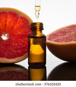 Grapefruit, essence, essential oil, extract, in amber glass bottle with dropper