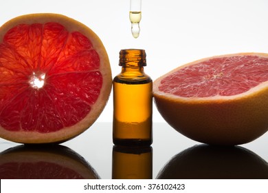 Grapefruit, essence, essential oil, extract, in amber glass bottle with dropper