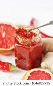 Grapefruit Marmalade (jam) With Chili Pepper. Unusual Jam. Spoon With Jam And Jar Close-up.