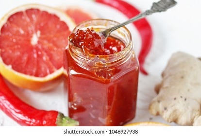 Grapefruit Marmalade (jam) With Chili Pepper. Unusual Jam. Spoon With Jam And Jar Close-up.