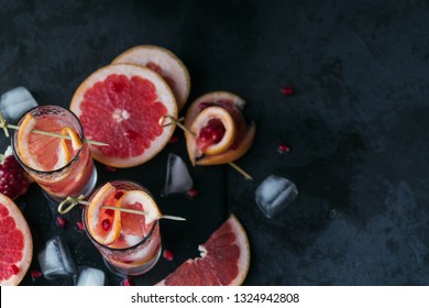 Grapefruit And Pomegranate Cocktail Or Mocktail, Refreshing Summer Drink With Crushed Ice And Sparkling Water. Top View