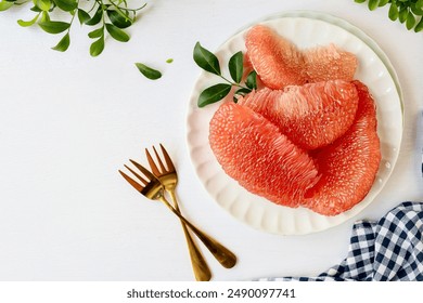 Grapefruit Ruby of Siam,Siam ruby ​​grapefruit,  tabtimsiam pomelo, red pomelo, in white plate on white table background, 