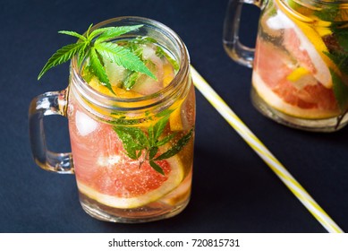 Grapefruit smoothie with marijuana leaves in jars